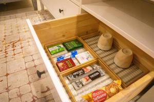 an open drawer in a kitchen with food at صالة وغرفتين نوم دخـول ذاتي in Al Kharj