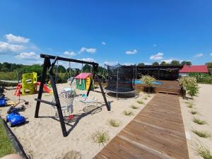 a playground with a swing set and a sandbox at NA KOŃCU WSI in Ruciane-Nida
