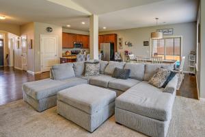 a living room with a large couch and a kitchen at Cozy South Carolina Retreat with Patio and Fireplace! in Greenville