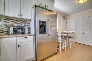 a kitchen with a stainless steel refrigerator and a table at Carson City Vacation Rental about 19 Mi to Lake Tahoe! in Carson City