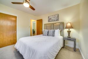 a bedroom with a large white bed and a lamp at Carson City Vacation Rental about 19 Mi to Lake Tahoe! in Carson City