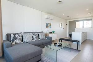 a living room with a couch and a table at Pebblebeach 2 bedroom Apartment in Sibaya