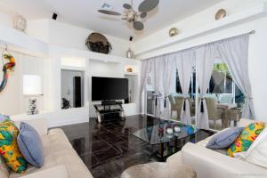 a living room with a couch and a glass table at Villa Bremen - Pool / Spa Home in Cape Coral