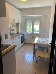 a kitchen with a table and chairs in a room at Alex Apartament in Mangalia