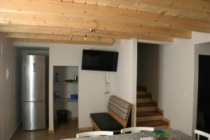 a living room with a television on a wall at Amistad y convivencia 1 in Barahona