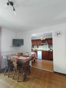 a kitchen with a wooden table and a dining room at Casa Vauterin VDA CIR 0019- 0021-0022-0026- in La Thuile