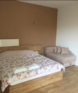 a bedroom with a bed with two books on it at Apartman "Alex & Nina" in Ulcinj