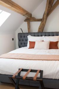 a bedroom with a large bed with a blue headboard at B&B Kraneveld in Haacht