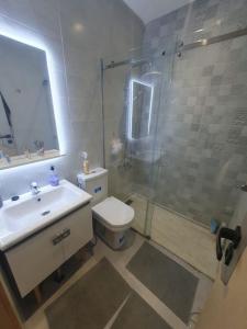 a bathroom with a sink and a shower and a toilet at Good Life Top House Btw Sea & Montain 