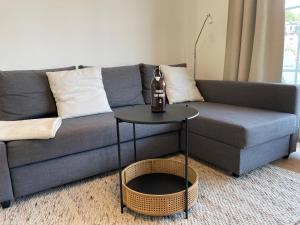 a living room with a couch and a table at NEU 2023 - Fewo mit Meerblick & Flair in Harrislee