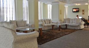 a living room with couches and a table and a person at Private Studio 1st line in Pomorie