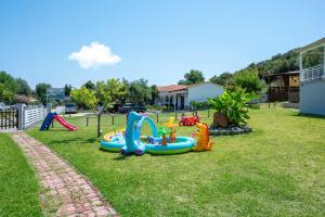 a playground with inflatable play equipment on the grass at Studios Vagelis in Kalamitsi