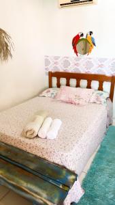 a bedroom with a bed with two towels on it at Pousada Nossa Senhora da Guia in Nobres