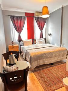 a bedroom with a large bed with a table and a table sidx sidx at Ahmet Efendi Evi in Istanbul