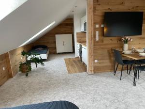 a living room with a dining room table and a tv at Apartmán u Ovečků - Nová Paka in Nová Paka