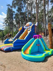 a group of slides in the sand at a playground at Gród Piasta in Gąsawa