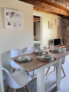 a wooden table with chairs and wine glasses on it at Apartamentos Numancia in Garray