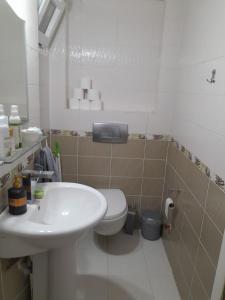 a bathroom with a white sink and a toilet at Denize Yakın Daire in Antalya