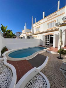 a house with a swimming pool in front of it at Villa 46 Hostel in Lagos