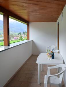 a white table and chairs in a room with a window at Chiara in Roncegno