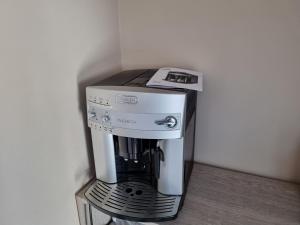 a coffee maker sitting on top of a stand at Apartament Nemo in Rowy