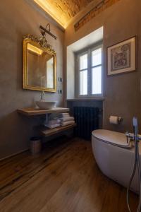 a bathroom with a tub and a sink and a mirror at Tenuta Bussia - Wine Relais & Spa in Monforte dʼAlba