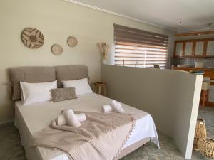 a bedroom with a bed with a blanket on it at Penthouse360view in Karistos