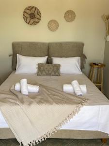 a large bed with white pillows on it at Penthouse360view in Karistos