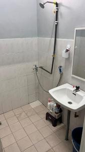a bathroom with a shower and a sink at 2 Bedroom house with Coway, all room air-cond, WIFI, Nettflix in Kampung Gurun