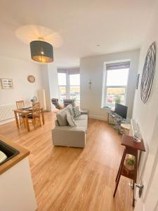 a living room with a couch and a table at Bellaview Apartment Barmouth in Barmouth