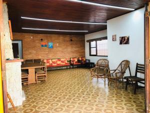 um quarto com cadeiras e mesas num quarto com em Casa na Enseada- Guaruja no Guarujá