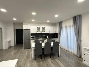 a kitchen with a table and chairs in a room at M&S Apartament 1 in Baile Felix