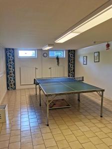 a ping pong table in the middle of a room at Saxvikens vandrarhem in Mora