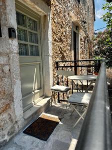 a patio with a table and chairs next to a door at Sailor's apartment in Supetar