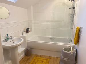 a bathroom with a tub and a sink and a shower at Idillic Two bed country cottage in Kirkby Thore