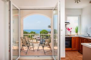 a kitchen with a balcony with a table and chairs at Sunrise Apartment Hvar in Hvar