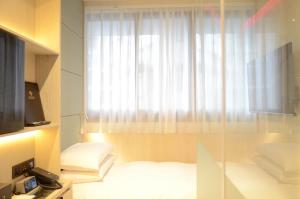 Voodi või voodid majutusasutuse Royal Jade Boutique Hotel toas