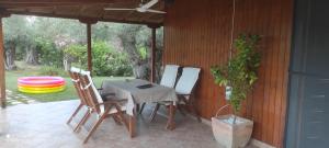 a table and chairs on a patio with a frisbee at Bills house in Mákri