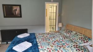 a bedroom with a bed with two towels on it at Blue Ensign Cottage in Weymouth