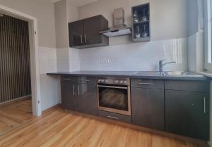 a kitchen with a sink and a stove at Ferienwohnung zum Hufi in Dahn +10 photos