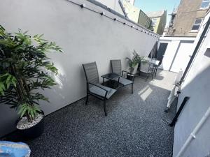 a balcony with chairs and plants on a building at new osborne luxury Hottub and jacuzzi suites in Blackpool