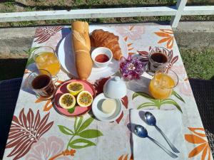 einen Frühstückstisch mit einem Teller Essen auf einer Decke in der Unterkunft Bungalow Miwa in Punaauia