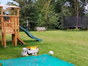 a playground with a toy truck on the grass at Kampeerplaats Glamping Essenhof in Aagtekerke