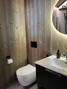 a bathroom with a white toilet and a sink at Sogndal Chalet in Sogndal +29 photos