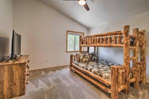 a bedroom with a bunk bed and a flat screen tv at Pine Cone Cabin in Pinetop-Lakeside
