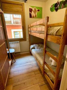 a room with two bunk beds and a window at Cal Querol - Puigcerdà centre in Puigcerdà