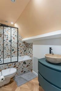 a bathroom with a sink and a toilet at Modern Guest -Sainte Eulalie in Sainte-Eulalie
