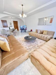 a living room with a couch and a table at Appartement En Bord de Mer in Tangier