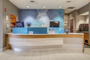 a lobby of a store with a blue counter at SpringHill Suites Gainesville in Gainesville