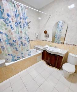 a bathroom with a sink and a toilet and a shower at Appartement En Bord de Mer in Tangier